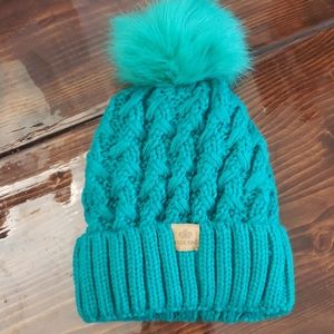 Greenish teal pom pom hat